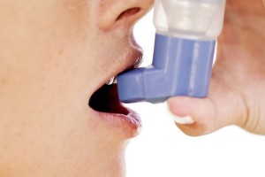 Woman Using an Inhaler
